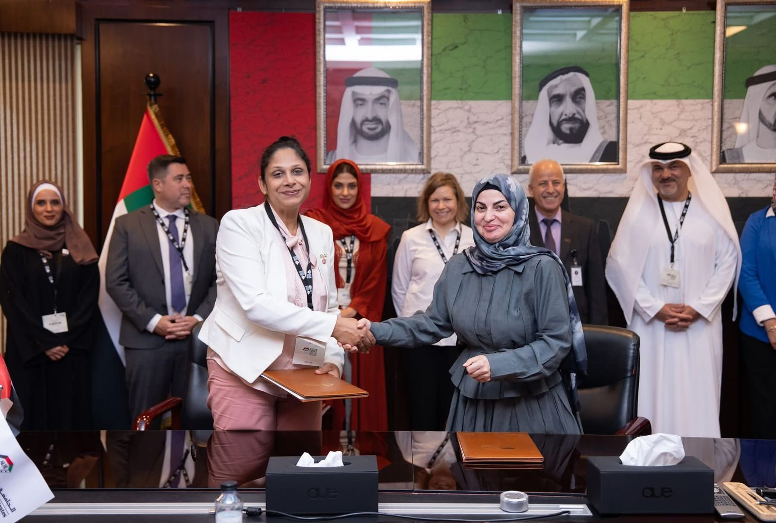 Handshake following the MoU signing between CMS Holoul and AUE